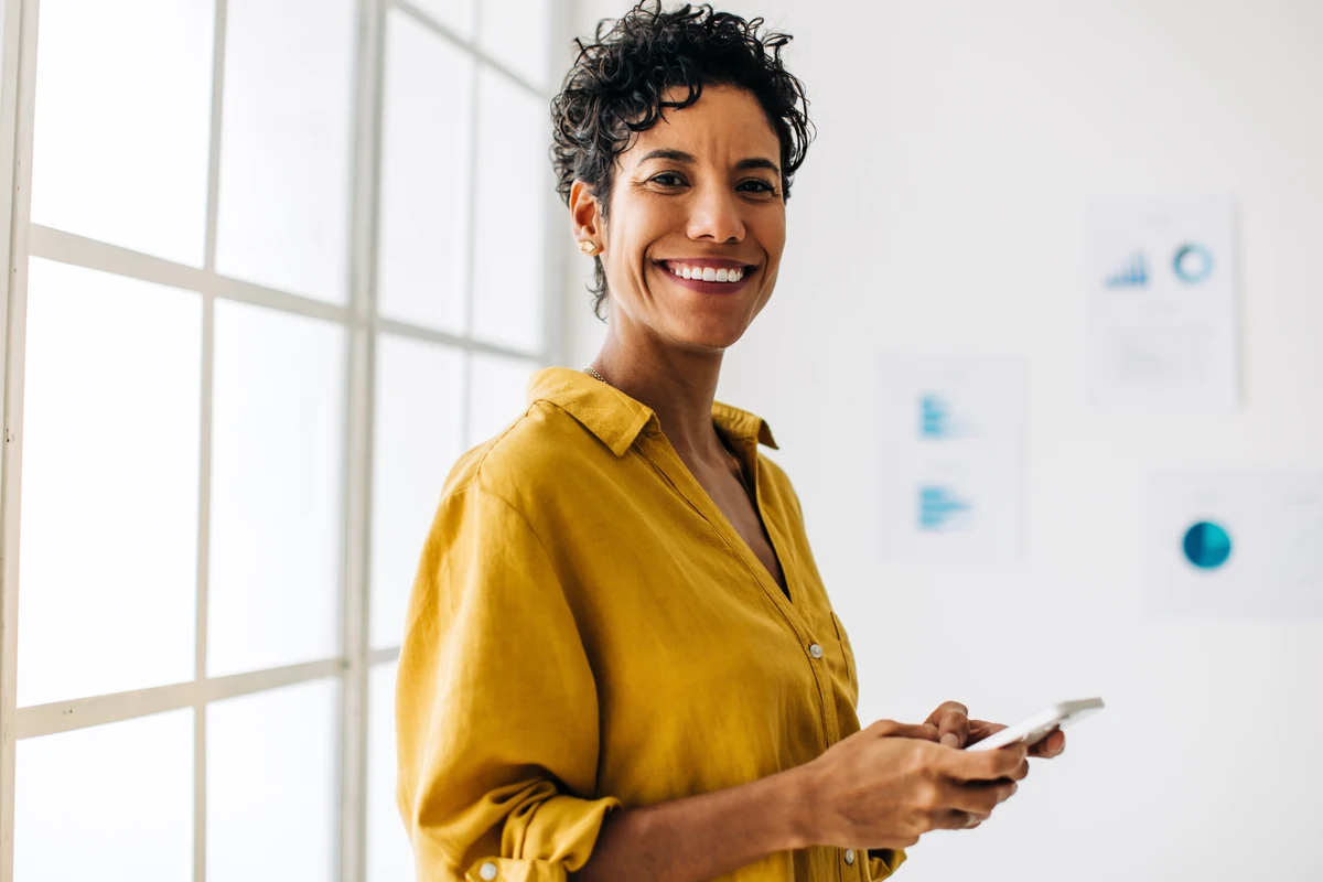 Smiling woman holding a tablet